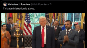 In a presidential office, people in suits and saris gather around a lit brass Diwali lamp; a man in a dark suit and red tie stands center, US flags behind, with an on-screen tweet: 'This administration is a joke.'