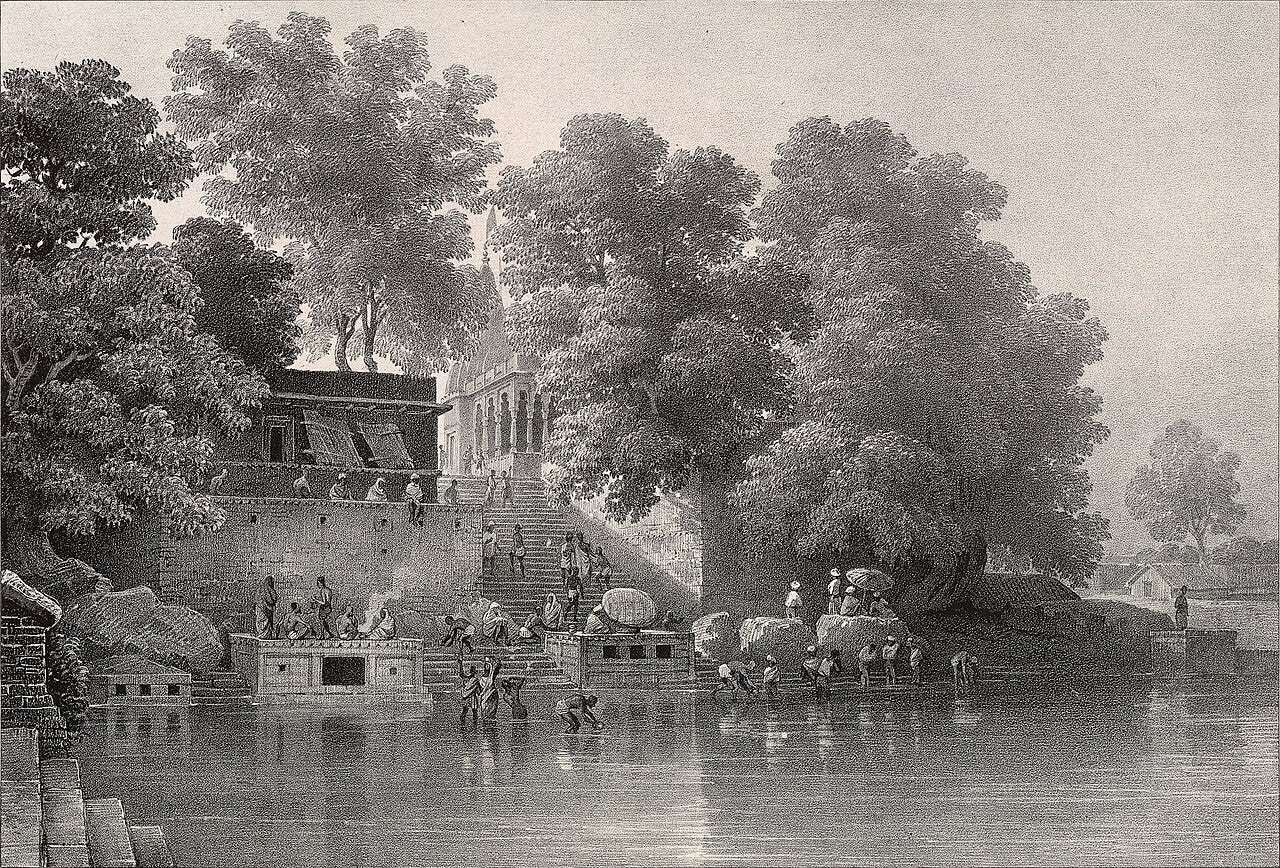 Antique engraving of Varanasi’s ghats on the Ganges, showing stone steps, shrines, and large banyan trees, with many people bathing, washing, and gathering along the riverbank in calm morning light.