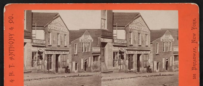 Stereograph of a dusty 19th-century street with wooden storefronts, including a building labeled Auction & Commission, recalling venues central to slavery debates in the antebellum United States.