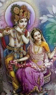 Painting of Hindu deities Krishna and Radha: a blue-skinned figure with peacock-feather crown plays a flute beside a woman in a pink sari; both wear garlands on a floral backdrop for Articles.