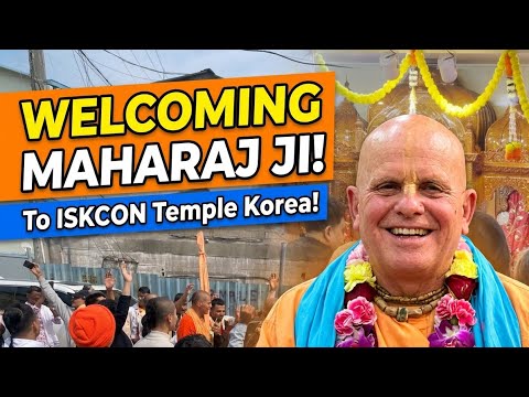 Close-up of a smiling spiritual leader in saffron robes and flower garlands at the ISKCON Temple Korea, while devotees cheer in a street kirtan; text shows 'Welcoming Maharaj Ji!'; testing.