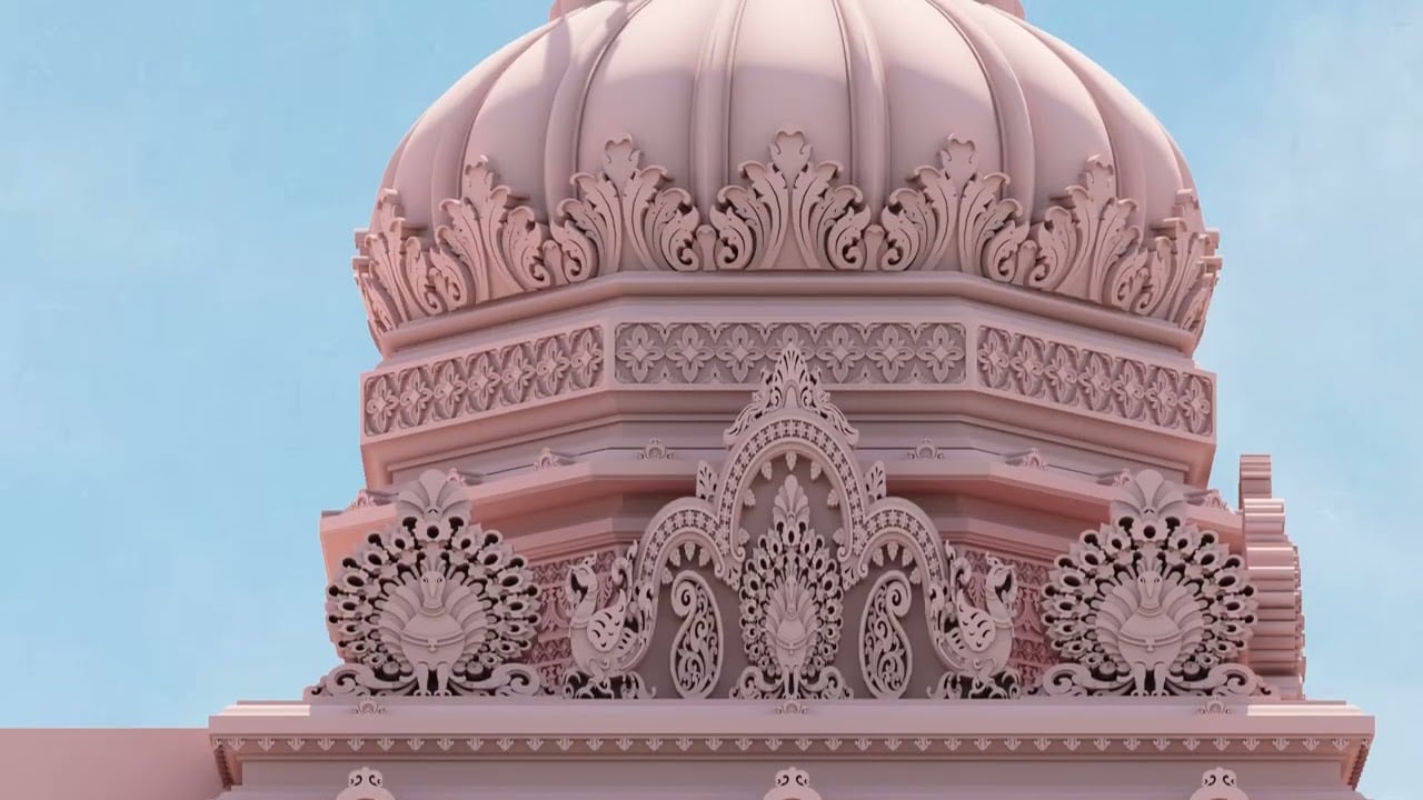 Close-up of a proposed temple dome from the ISKCON Los Angeles master plan, showing pink stonelike surfaces, dense floral scrollwork, and twin peacock motifs under a clear sky; rendering.