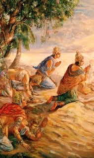 Devotional painting of crowned devotees bowing on a riverbank, palms joined in prayer toward a bright, unseen deity, evoking bhakti and the causeless mercy of Krishna in Hindu devotional art.
