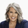 Studio headshot of a smiling adult with short gray hair in a navy blazer on a white background; header image for a blog on letting go, acceptance, healing grief, past challenges, and wisdom.