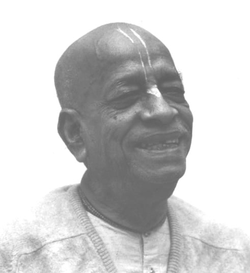 Black-and-white portrait of a smiling elderly man with a bald head and vertical forehead markings, in a light sweater; image for an Articles feature on parrots, reflection, and meaningful storytelling.
