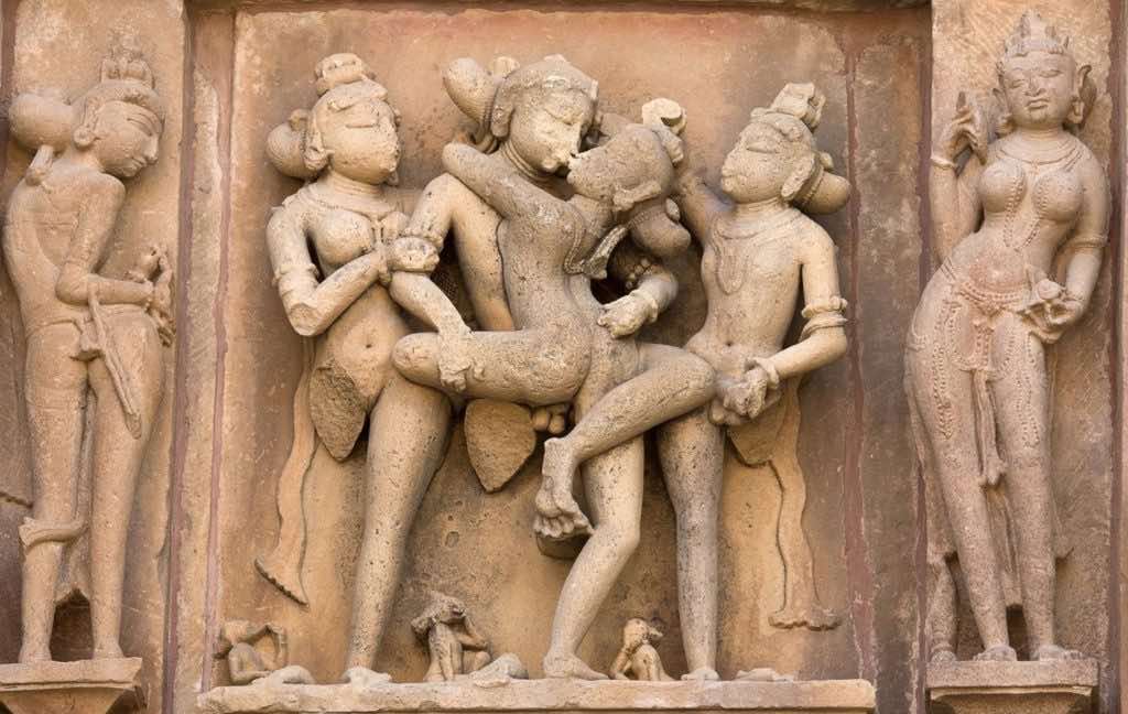 Ancient Indian temple relief of entwined figures, symbolizing tantra, desire, Awakening, community, Dharma teachings, and The Path