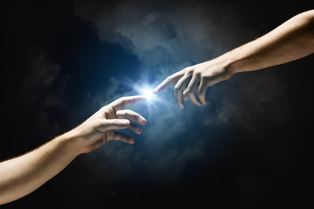 Two human hands reaching toward a bright light in a dark sky, symbolizing spiritual connection, true love, lasting happiness, and lifestyle purpose.