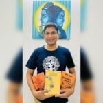 Smiling reader holding Bharat That Is India by Abhijit Joag, relevant to an Indian Book Review on Bharat, Dharma, and Bharatiya civilization.