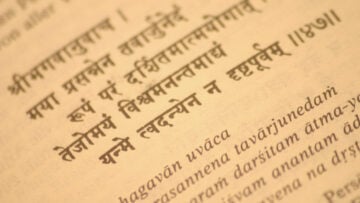 Close-up of Sanskrit and transliterated text on an aged page, evoking Dharma, Bharat, and Bharatiya civilization for an Indian book review.