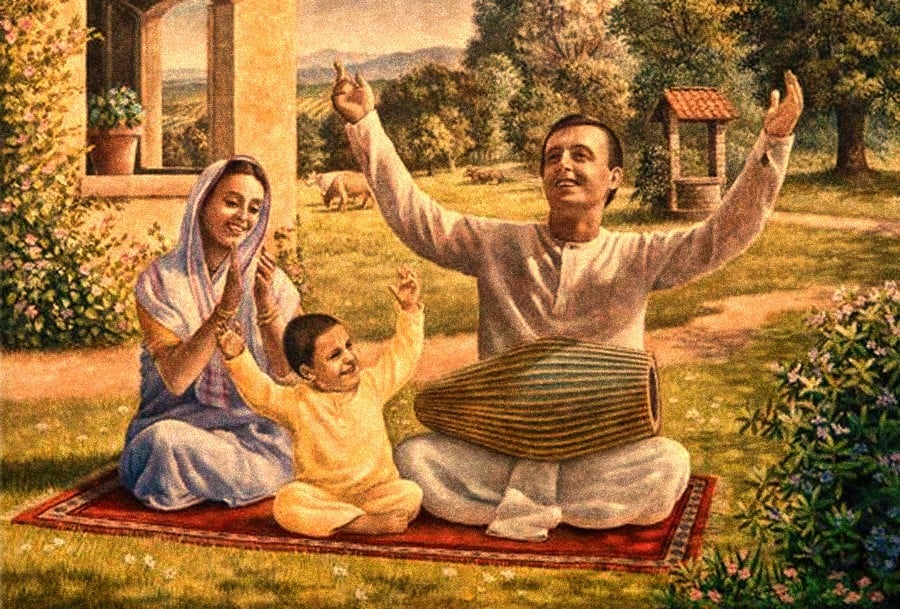 Painting of a devotional family seated on a rug in a garden, with a father playing a drum, mother praying, and child raising a hand in ideal family life.