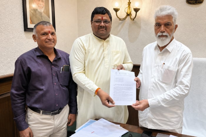 Three men in an office hold a memorandum during an HJS appeal on restoring Chhatrapati Shivaji Maharaj and Maratha Empire references in NCERT textbooks.