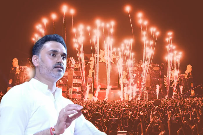 Man in a white kurta shown against a crowded concert stage with fireworks, illustrating Maharashtra music concert alcohol ban and Sunburn Festival probe