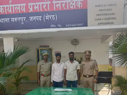 Meerut Police officers stand with two detained suspects and seized items outside Sardhana police station in Uttar Pradesh cow slaughter case.