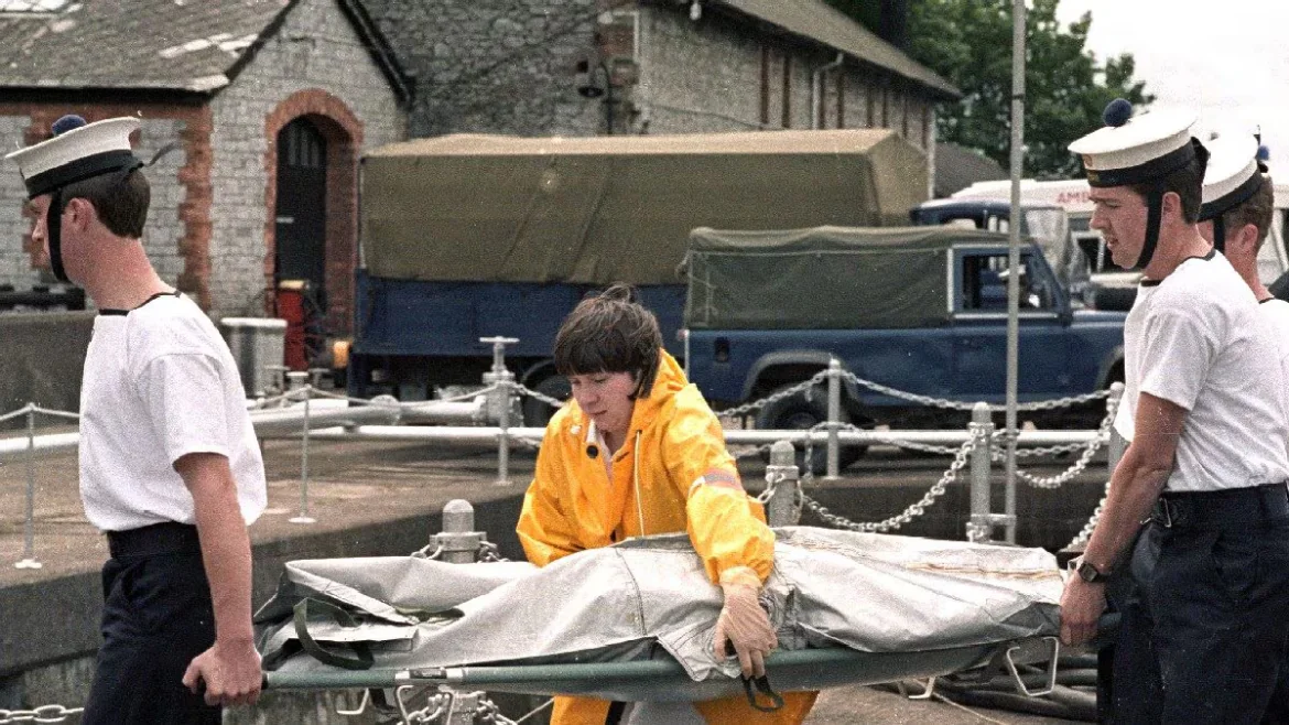 Rescue personnel carry a covered stretcher at a harbor during Air India Flight 182 recovery, evoking Canada, Khalistani terror, Bharat and World terrorism.