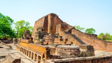 Ancient brick temple ruins with stairways and weathered walls under a clear sky, evoking Sri Rangam travelogue themes of Vaishnava heritage.