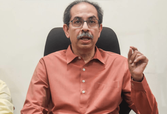 Uddhav Thackeray of Shiv Sena (UBT) seated in a meeting, gesturing while discussing BJP, Hindutva, China and Ram Mandir issues for Hindu Existence coverage.