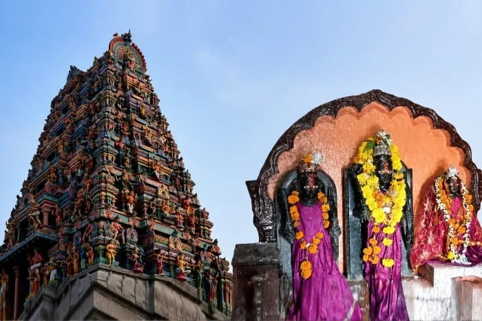 Colorful Hindu temple gopuram beside garlanded deity idols, used with news on the Ichalkaranji police case involving minor Hindu girls.