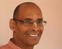 Smiling portrait of Sesa dasa with glasses, featured for an Alachua Temple Live Srimad-Bhagavatam class on SB 3.24.11.