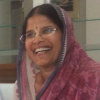 Madhumati devi dasi smiling in a pink sari and glasses, portrait image for Alachua Temple Live Srimad-Bhagavatam SB 3.24.11 class.