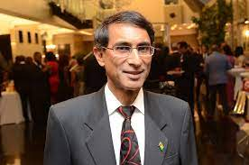 Portrait of a Bharatiya diaspora heart health speaker in a suit at an indoor event, highlighting World and Bharat concerns on cardiac disease.