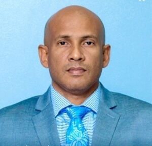 Portrait of a cardiology speaker in a blue suit and tie, linked to World and Bharat coverage on Bharatiya diaspora heart health risks.