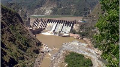 Hydropower dam across a muddy mountain river, illustrating Indus Waters Treaty disputes, Bharat geopolitics and transboundary water strategy.
