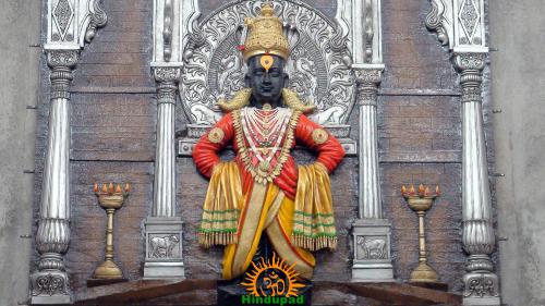 Lord Vitthal idol at Pandharpur Temple with crown, garlands, oil lamps and silver shrine, for Vitthal Navratri and Ashad Navratri Vratas-Pujas