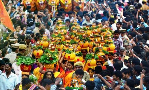 Women carry decorated Bonalu pots through a crowded Hyderabad Bonalu procession for Mahankali Bonalu Jatara and Vratas-Pujas celebrations.
