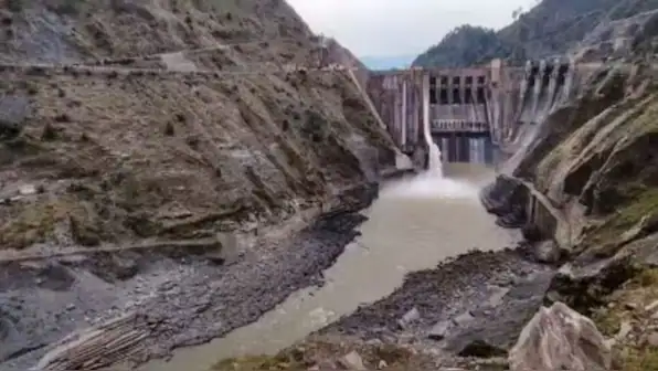 Hydroelectric dam releasing water through a rocky gorge, illustrating Bharat’s Indus Waters Treaty geopolitics and river project dispute.