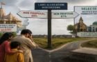 News graphic of people beside a rural signpost pointing to temple traditions and robotic elephants, for HHR Videos on Hindu temple elephants and PETA India.