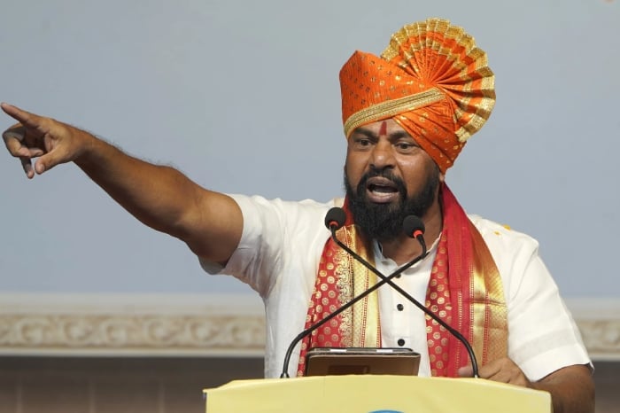 A bearded man in an orange turban speaks at a podium with microphones, illustrating news on the Bombay High Court mosque loudspeaker ruling