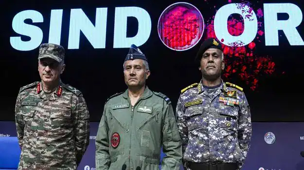Three Indian military officers stand on a stage before a large SINDOOR backdrop, illustrating Bharat geopolitics and Indus Waters Treaty tensions after Pahalgam.