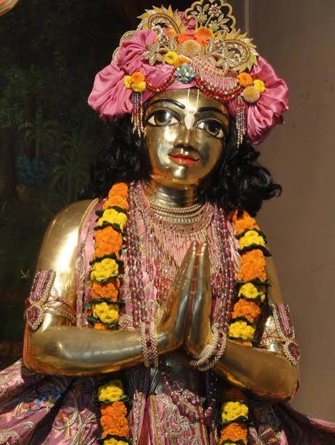 Golden Vaishnava deity with folded hands, floral garlands and pink crown, illustrating Srivasa Pandit remembrance in Lord Chaitanya tradition
