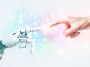Human finger touching a robotic hand with a glowing spark, symbolizing technology, modern learning, and the enduring legacy of Bhai Mani Singh.