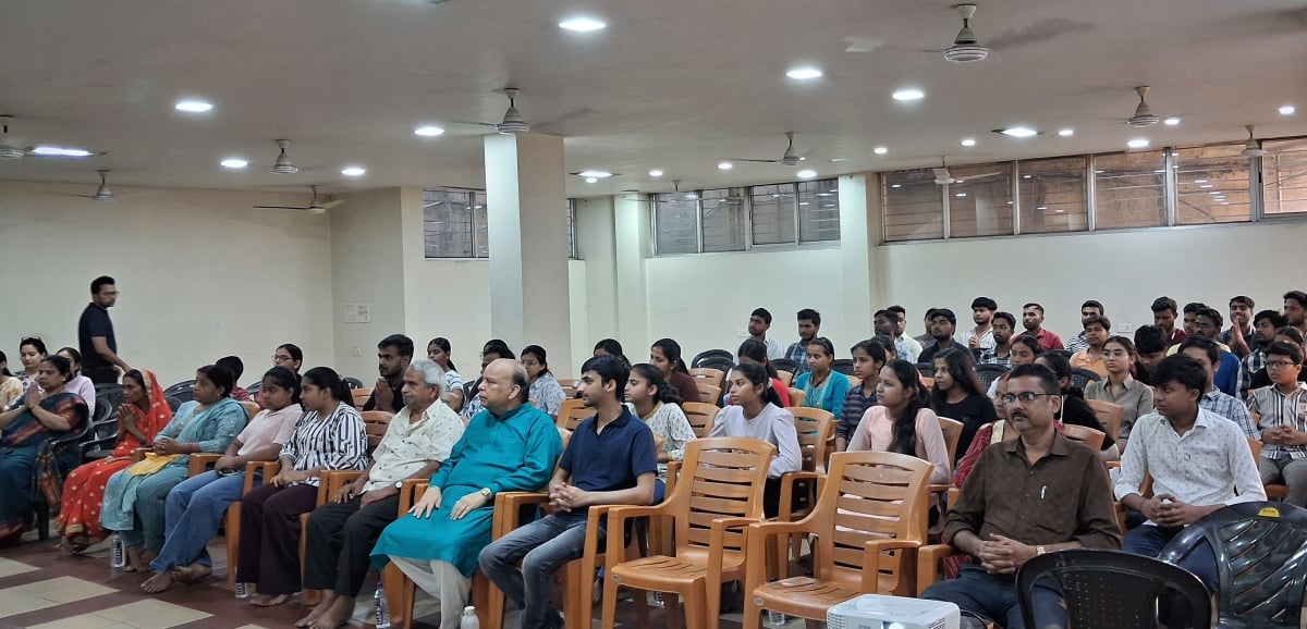 Audience seated in a hall during a Hindu Rashtra-Jagruti Abhiyan session in Jharkhand, with youth and community members attending the program.
