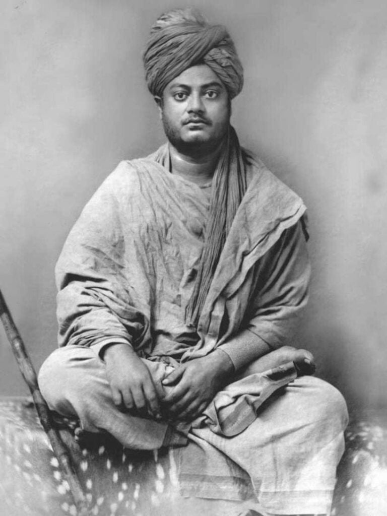 Black-and-white seated portrait of Swami Vivekananda in a turban and traditional robes, representing his teachings on Hindu Dharma and Vedanta in Bharat.