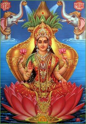 Goddess Lakshmi seated on a pink lotus, holding flowers and blessing devotees, with two elephants behind her, for Shravana Masam 2026 Vratas-Pujas.