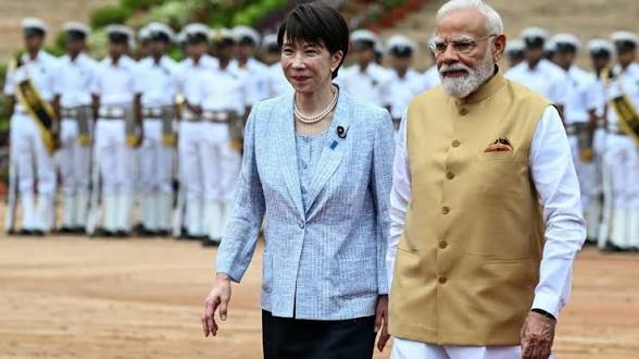 Bharat’s Prime Minister Narendra Modi walks beside a Japanese leader at a formal ceremony, with a military honour guard lined up behind them.