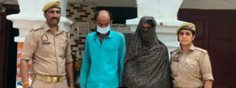 Two Uttar Pradesh police officers stand beside a masked man and a veiled woman presented as accused in the Saharanpur cow slaughter case.
