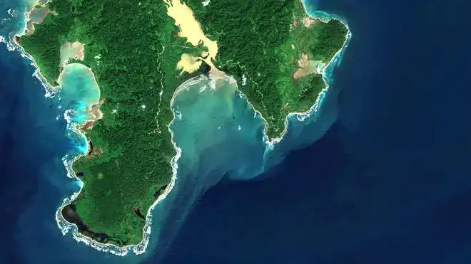 Satellite view of Great Nicobar Island’s forested coastline and turquoise Galathea Bay, a strategic site for Bharat’s Indo-Pacific infrastructure plans.