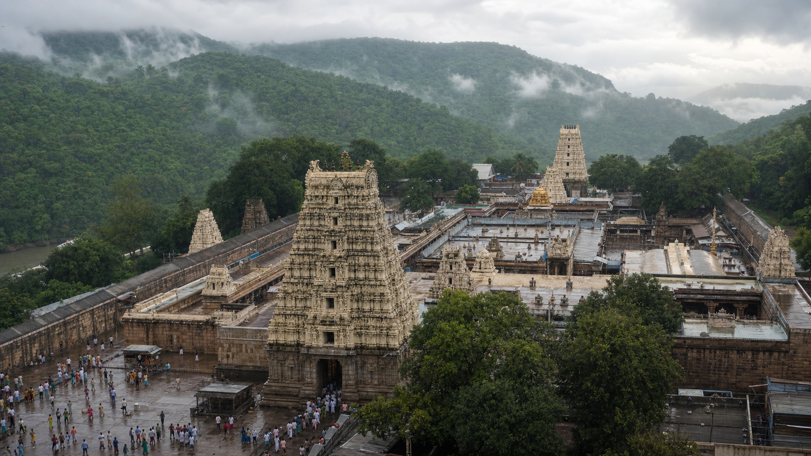 Srisailam Temple complex with pilgrims and mist-covered Nallamala Hills during the monsoon season.