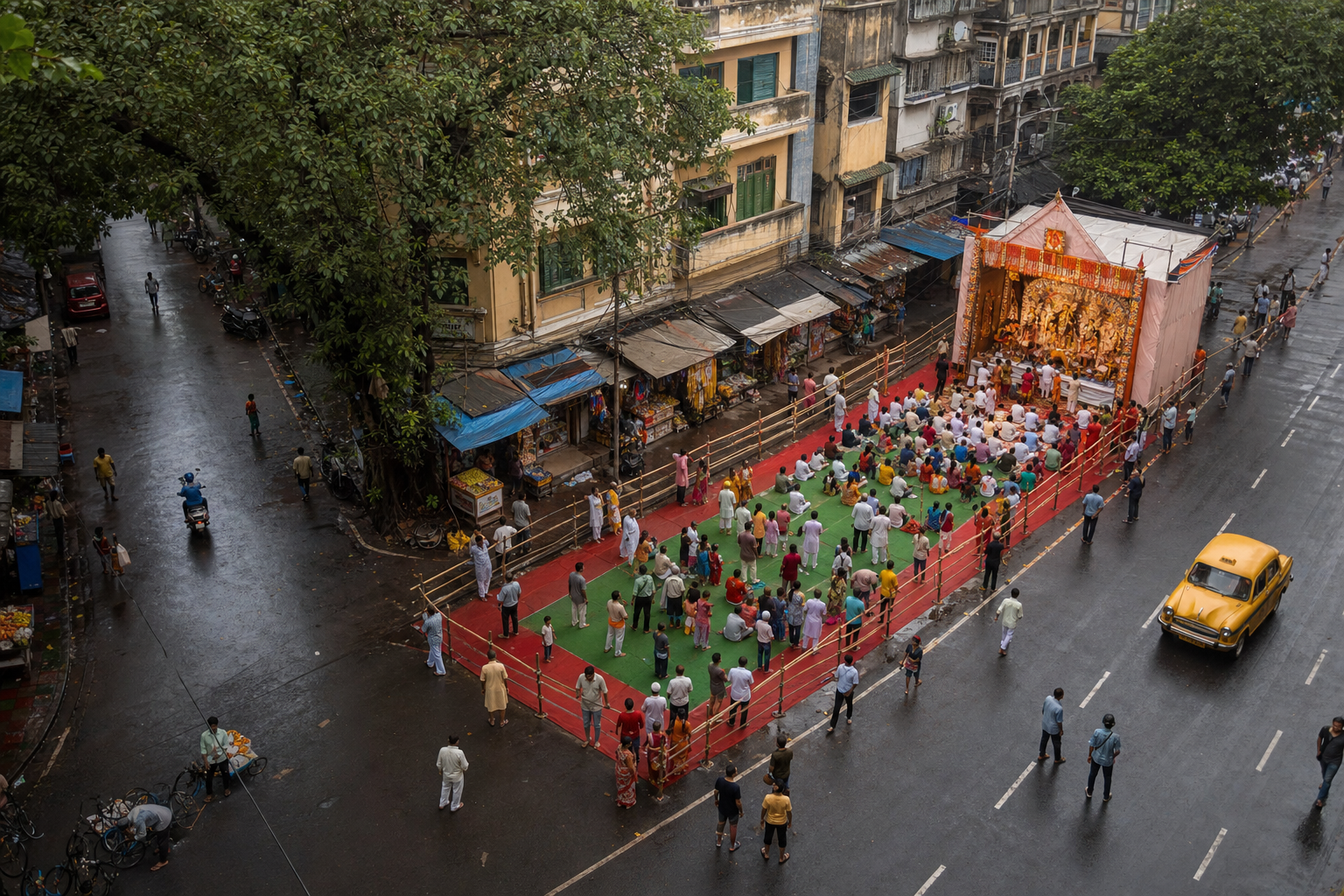 An overhead view of a Kolkata street gathering with barriers preserving pedestrian, shopfront and emergency access routes.
