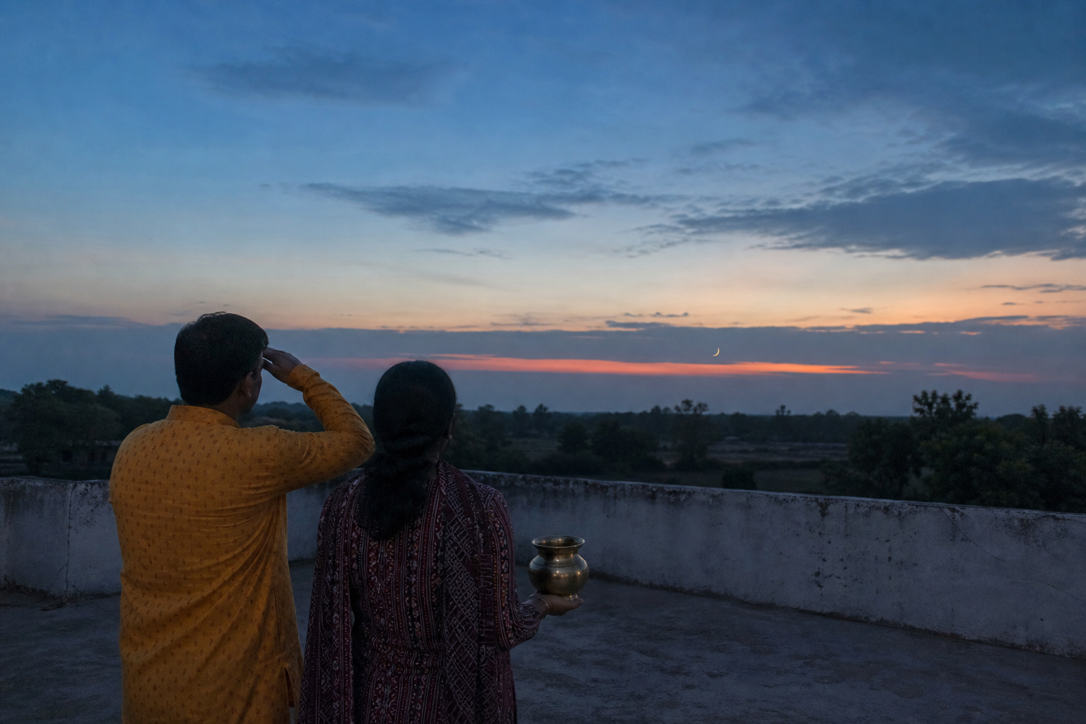 Two people watch for a thin crescent low over the western horizon from a rooftop after sunset, with a brass offering vessel nearby.
