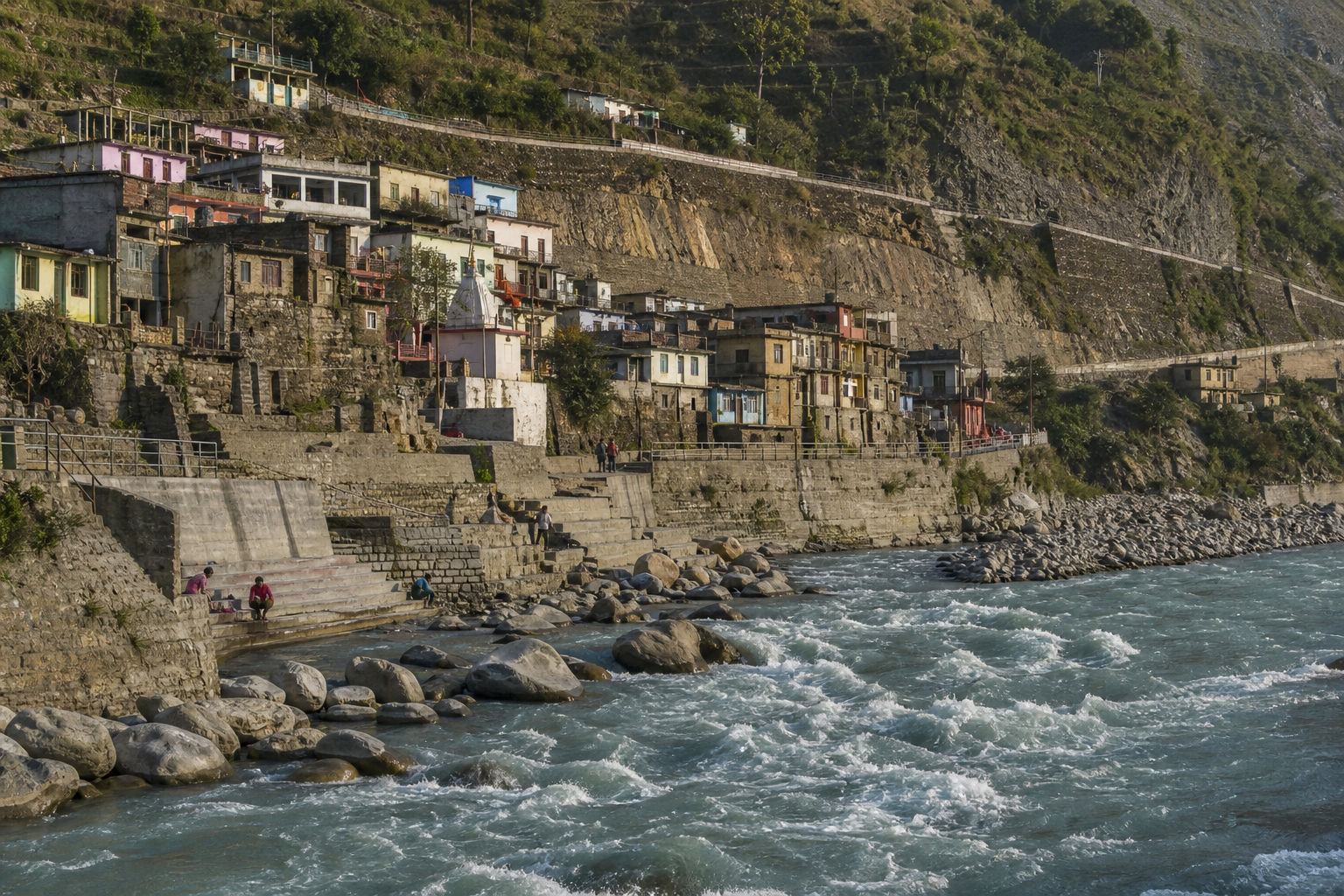 River channel, boulders, ghat steps, hillside buildings, road and terraced slopes in the Nandprayag valley.