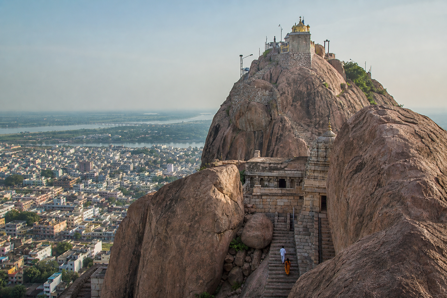 Ancient granite, stone-cut steps, temple structures, and the summit shrine form the layered landscape of Trichy Rockfort.