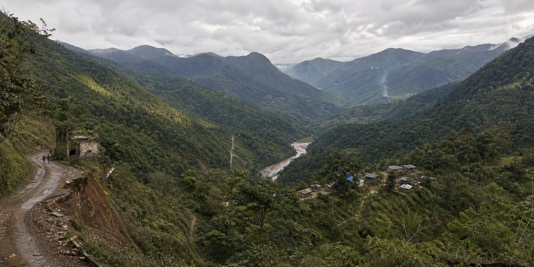 Forested mountains near the India-Myanmar frontier with remote villages, disrupted roads, footpaths and distant smoke in separate valleys.