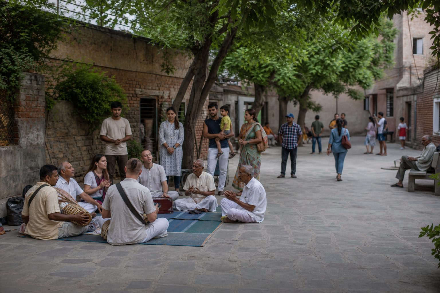 A small acoustic Harinam circle shares a neighborhood courtyard with local residents and passersby.