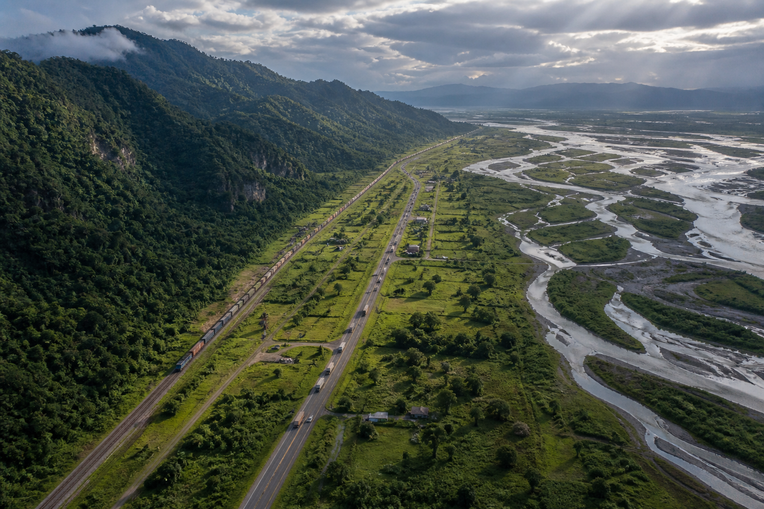 Road and rail routes pass through a narrow green plain between Himalayan foothills and river country.