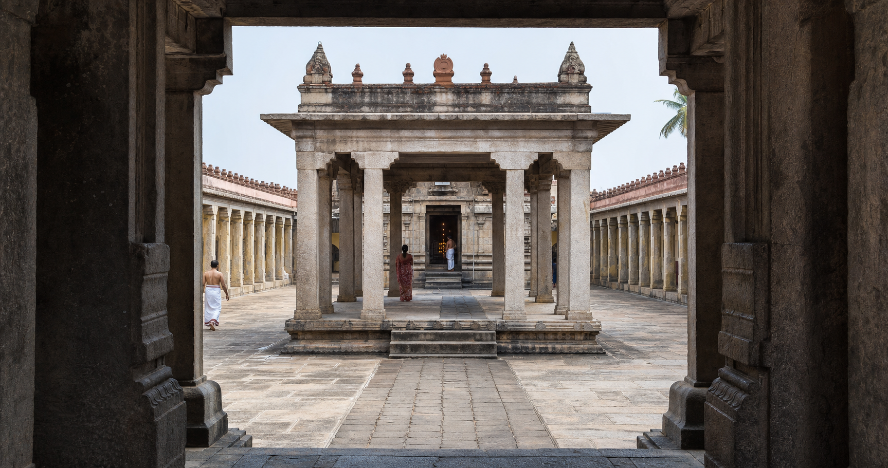 A view through the temple gateway connects the outer courtyard, granite pillared hall, and lamp-lit sanctum entrance.