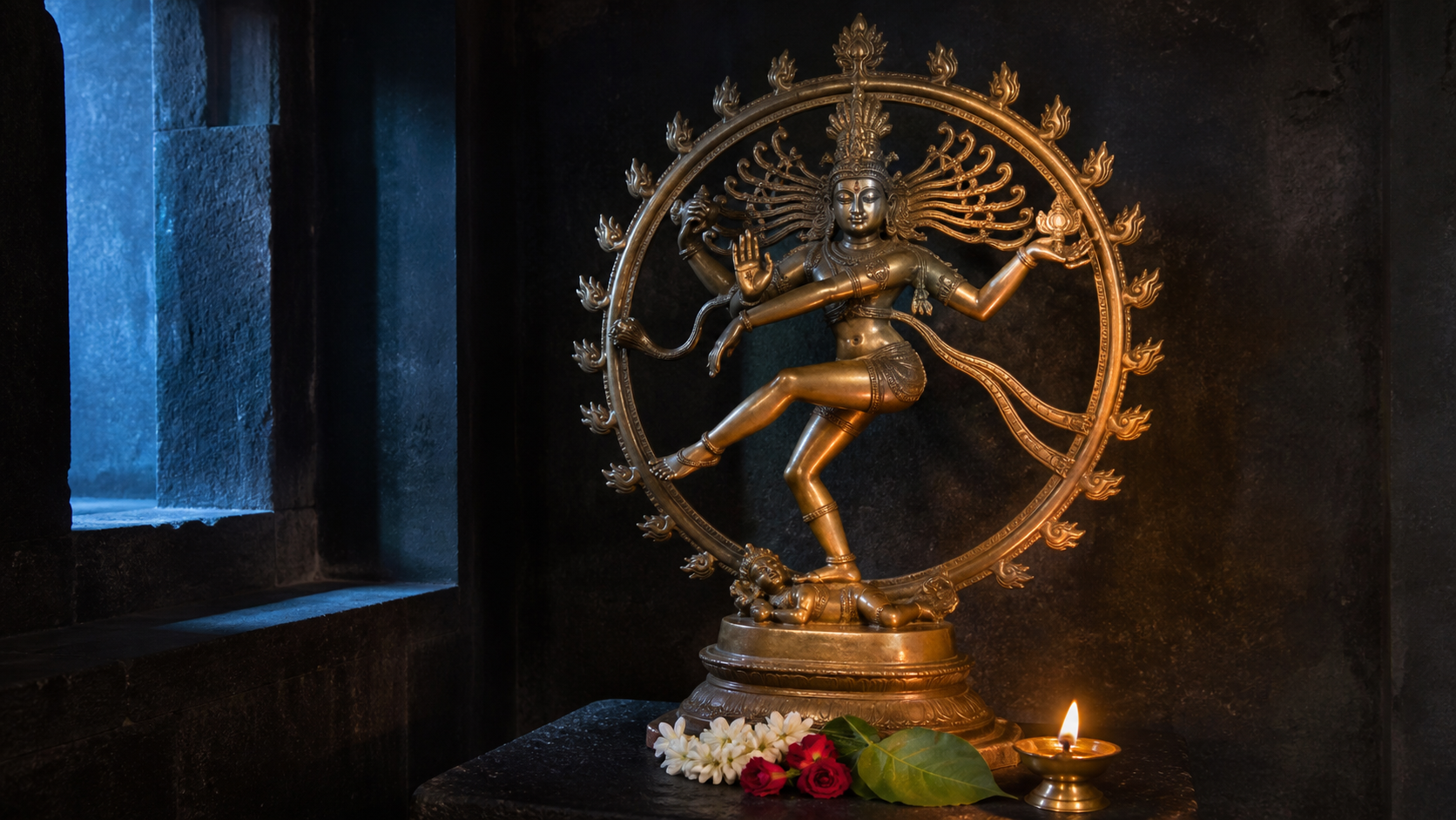 Bronze Nataraja murti beside an oil lamp, flowers, and Bilva leaves in a quiet shrine lit by warm flame and cool predawn light.